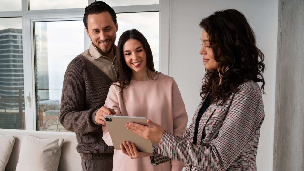 real estate agent showing a couple a virtual tour in a tablet